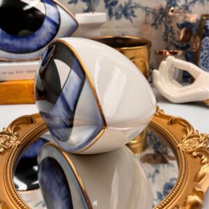 Side view of blue All-Seeing Eye porcelain paperweight