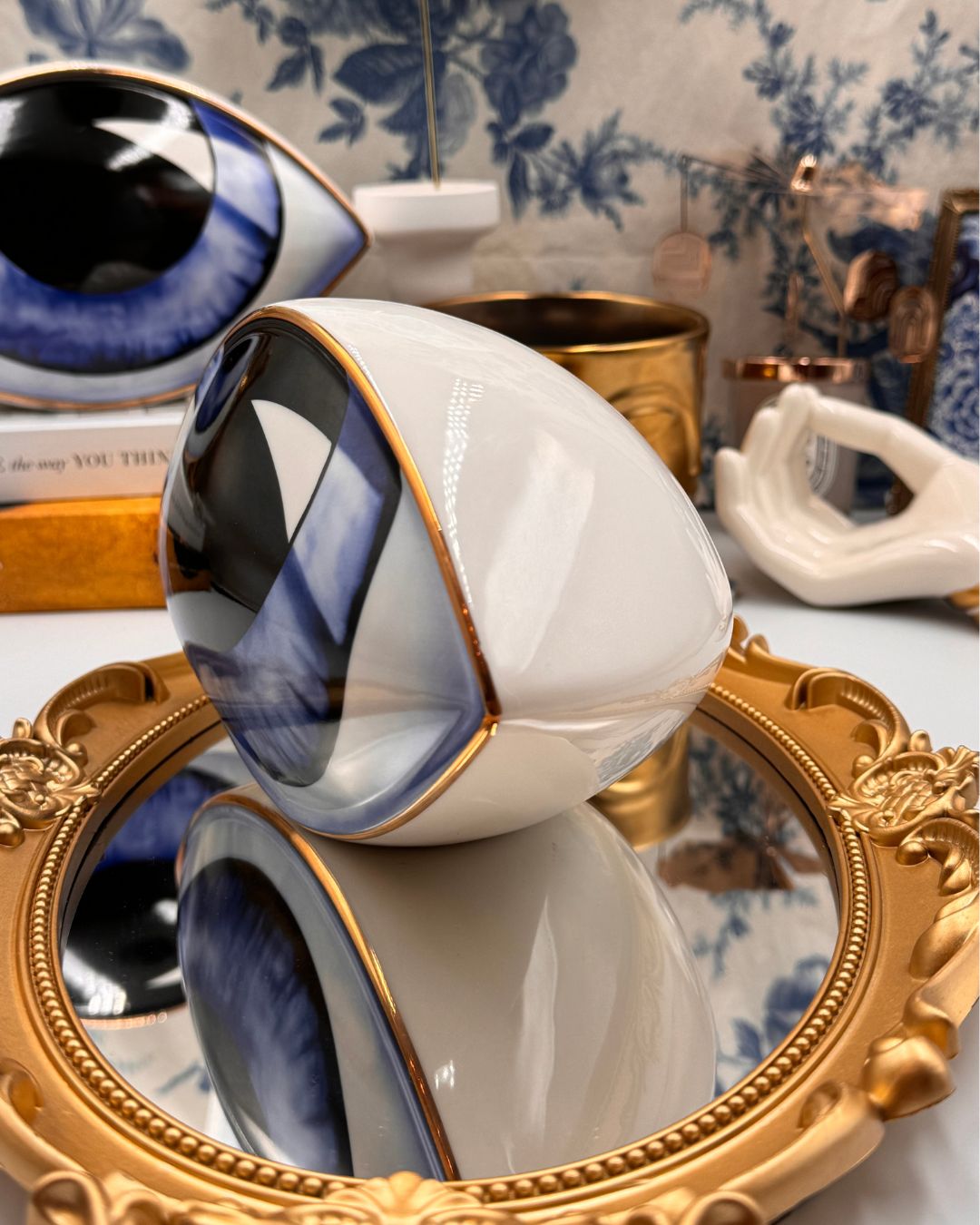 Side view of blue All-Seeing Eye porcelain paperweight
