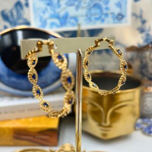 Repeating blue evil-eye motifs on CRYSTAL HAZE