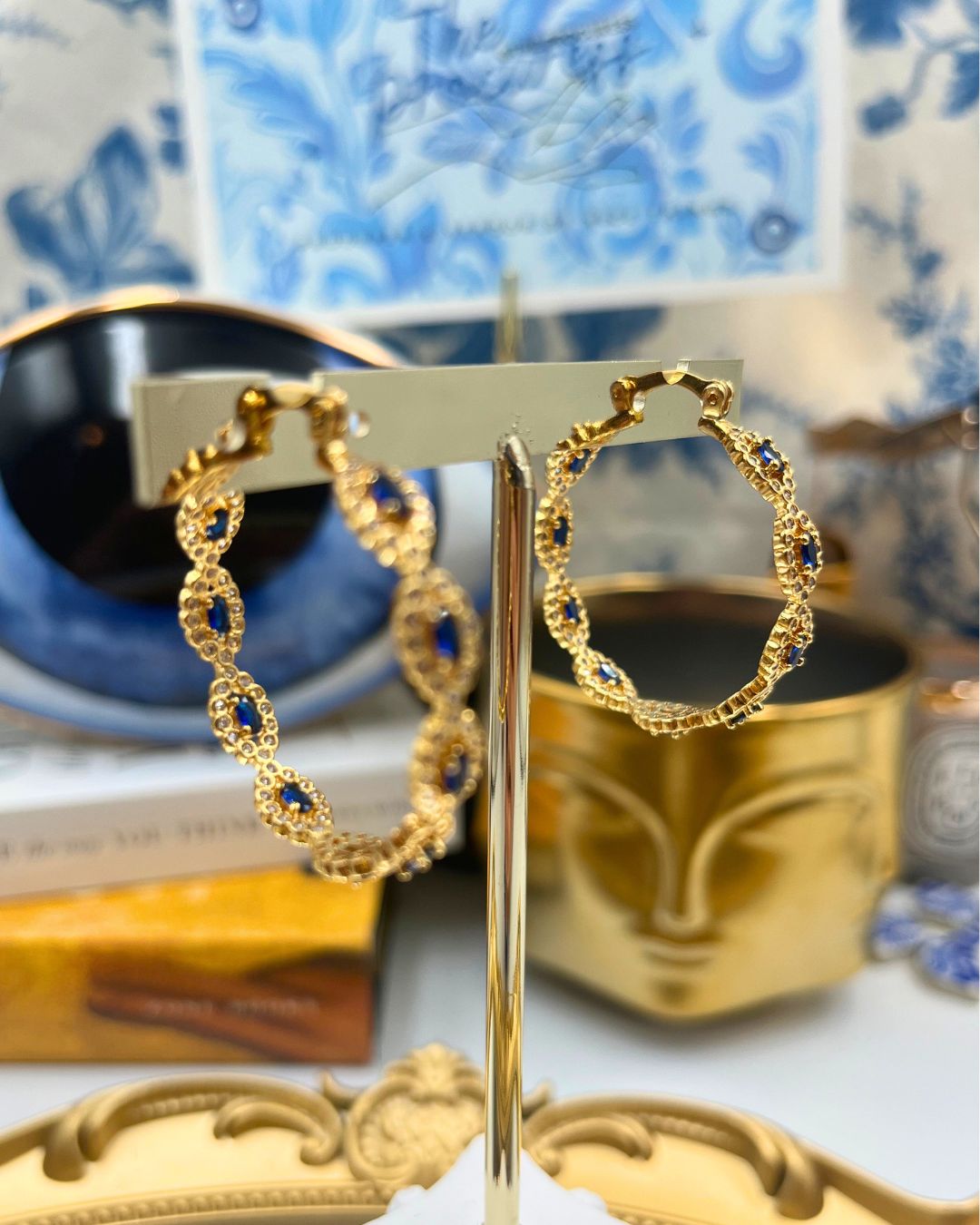 Repeating blue evil-eye motifs on CRYSTAL HAZE