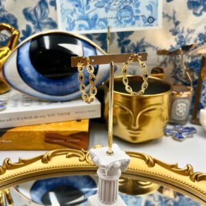 CRYSTAL HAZE Evil Eye Hoops displayed in a decorative still life