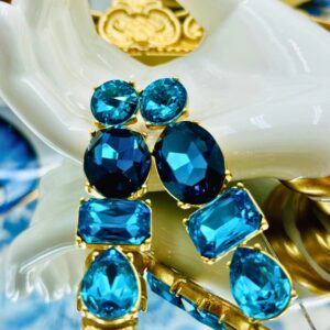 Mixed-cut blue Swarovski crystals in gold-tone settings on OSCAR DE LA RENTA earrings