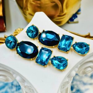 Side view of OSCAR DE LA RENTA gold-tone blue crystal drop earrings