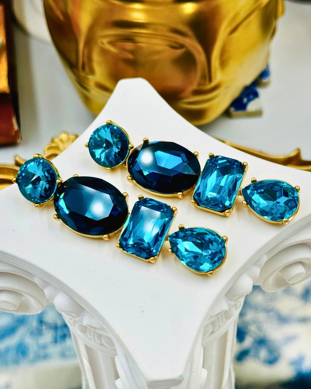 Side view of OSCAR DE LA RENTA gold-tone blue crystal drop earrings