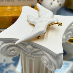 Gold-tone olive branch detail on white dove brooch
