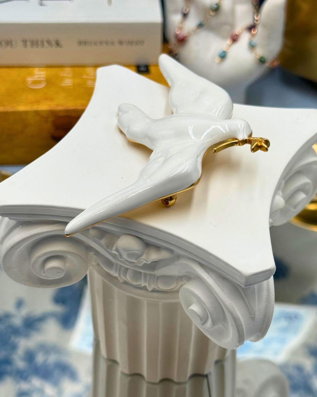 Gold-tone olive branch detail on white dove brooch