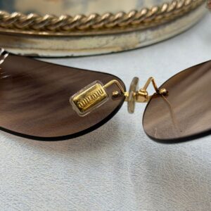 MIU MIU logo detail on interior gold-tone nose pads