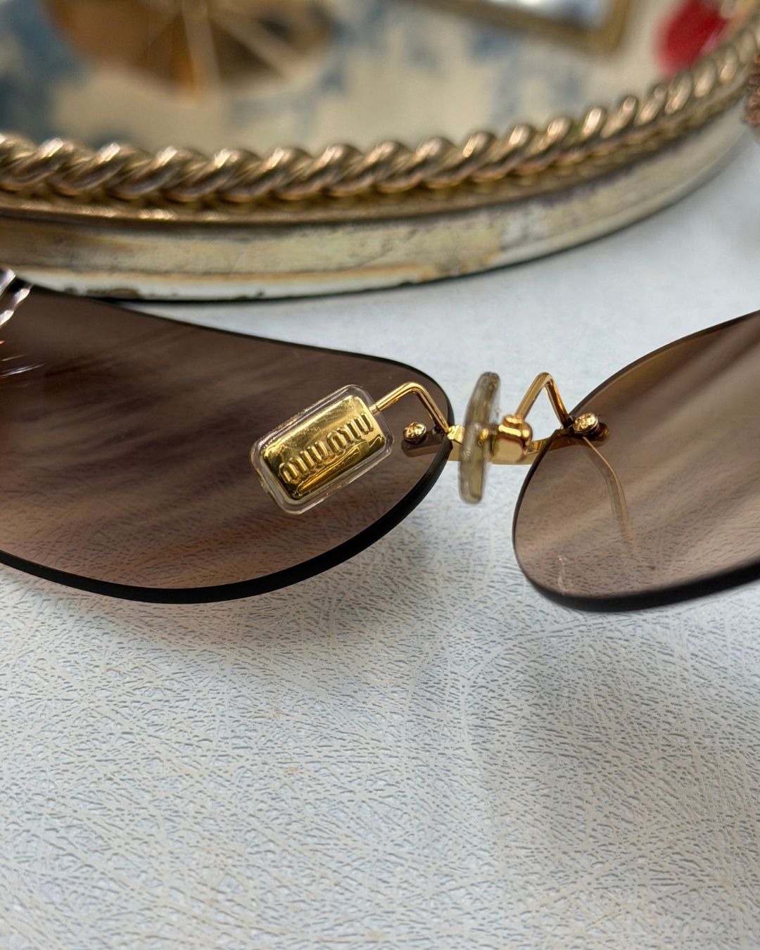MIU MIU logo detail on interior gold-tone nose pads