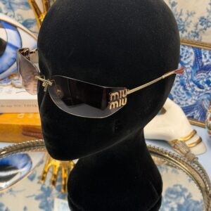 MIU MIU A51S bronze rimless sunglasses worn to show oversized rectangular shape