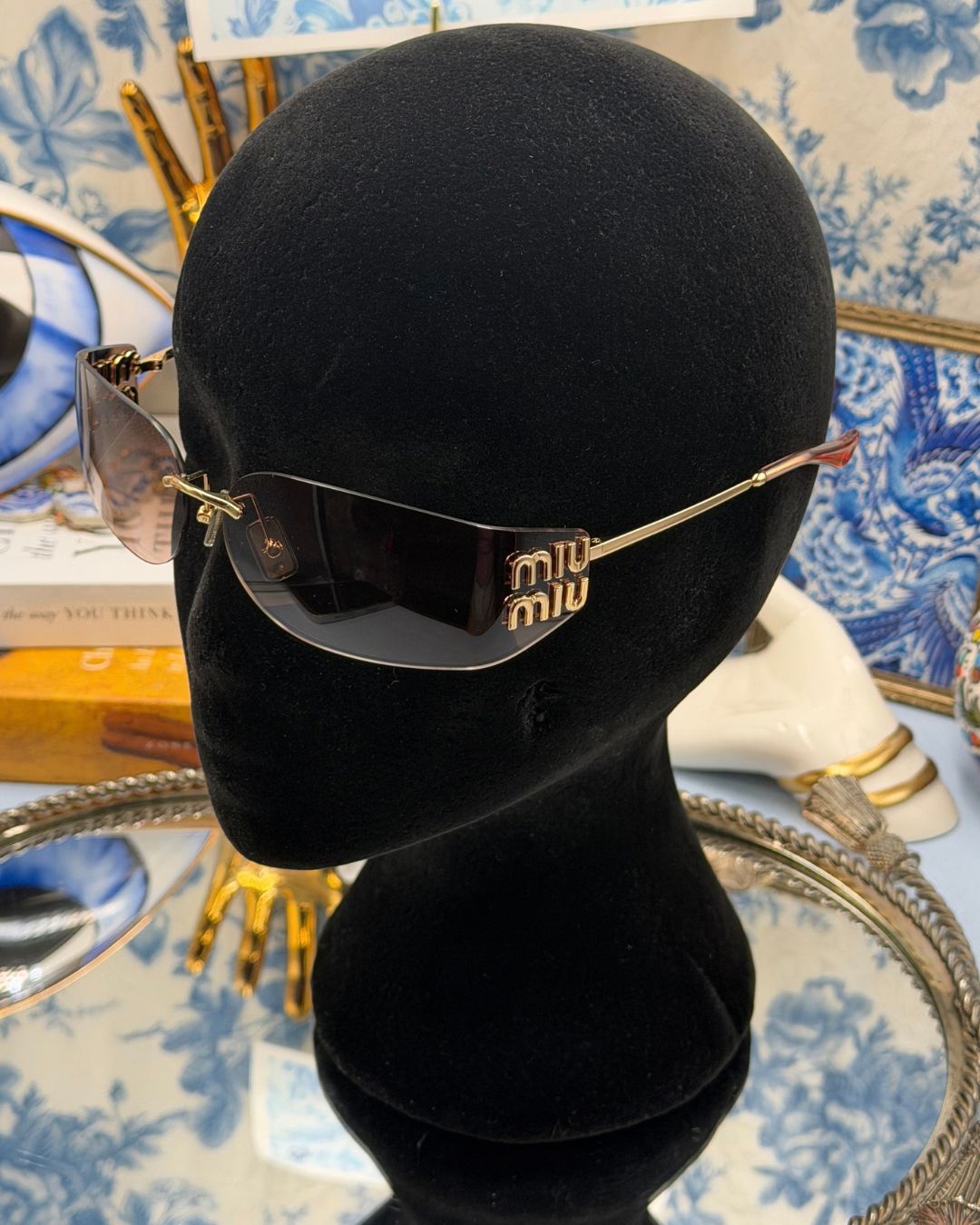 MIU MIU A51S bronze rimless sunglasses worn to show oversized rectangular shape