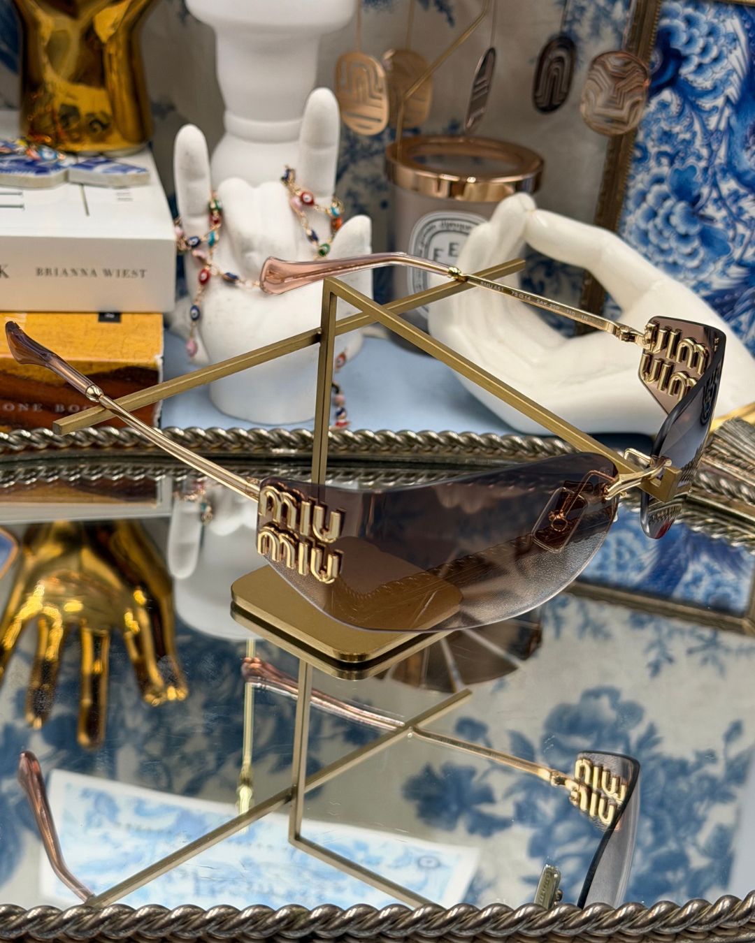 Angled view of MIU MIU A51S bronze rimless sunglasses