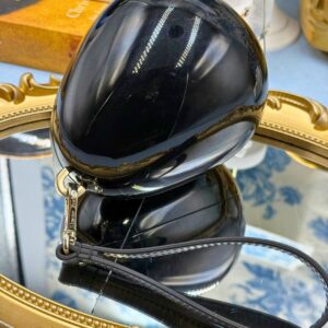 Side view of SIMONE ROCHA black Perspex Egg Clutch