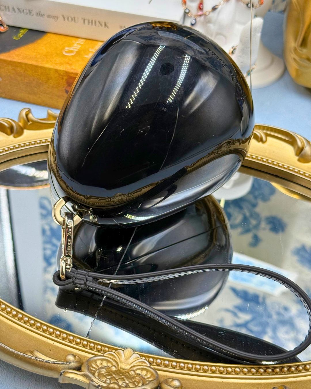 Side view of SIMONE ROCHA black Perspex Egg Clutch