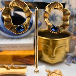 Front view of OSCAR DE LA RENTA gold O earrings with blue glass stones