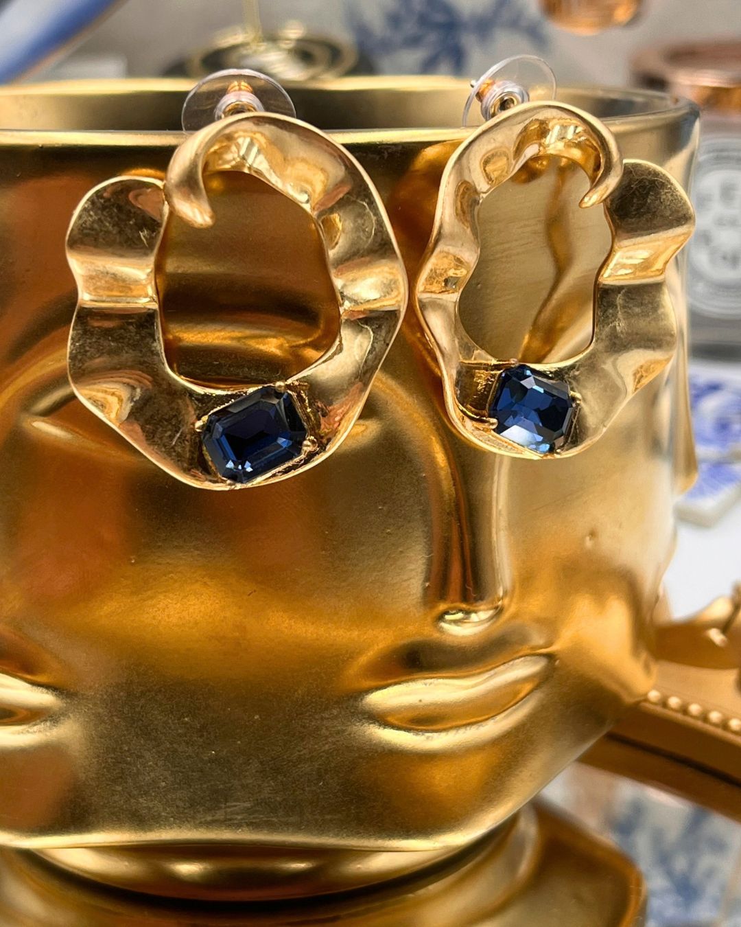 Pair of OSCAR DE LA RENTA sculptural gold O earrings with blue stones