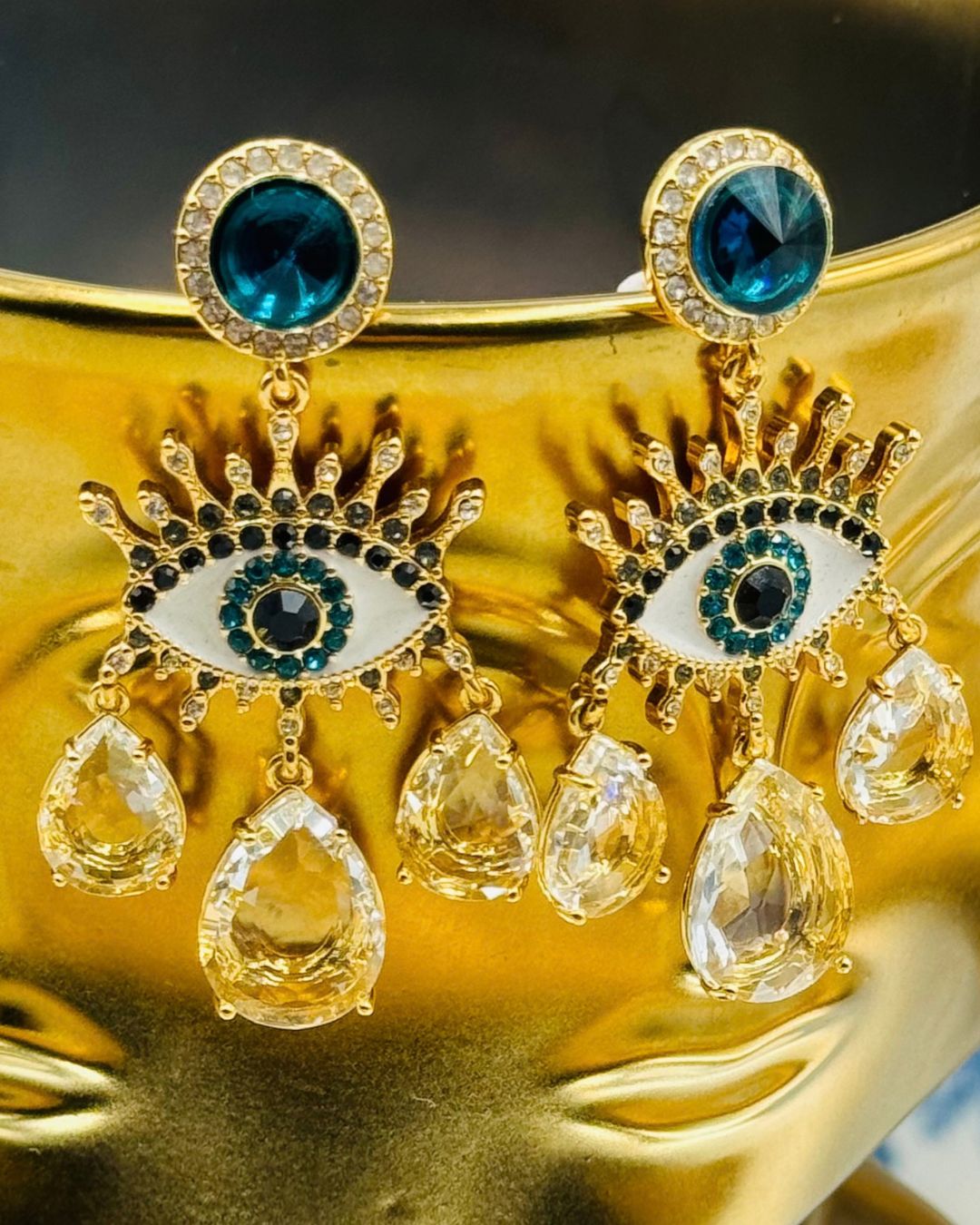 Front view of KURT GEIGER LONDON Evil Eye chandelier earrings