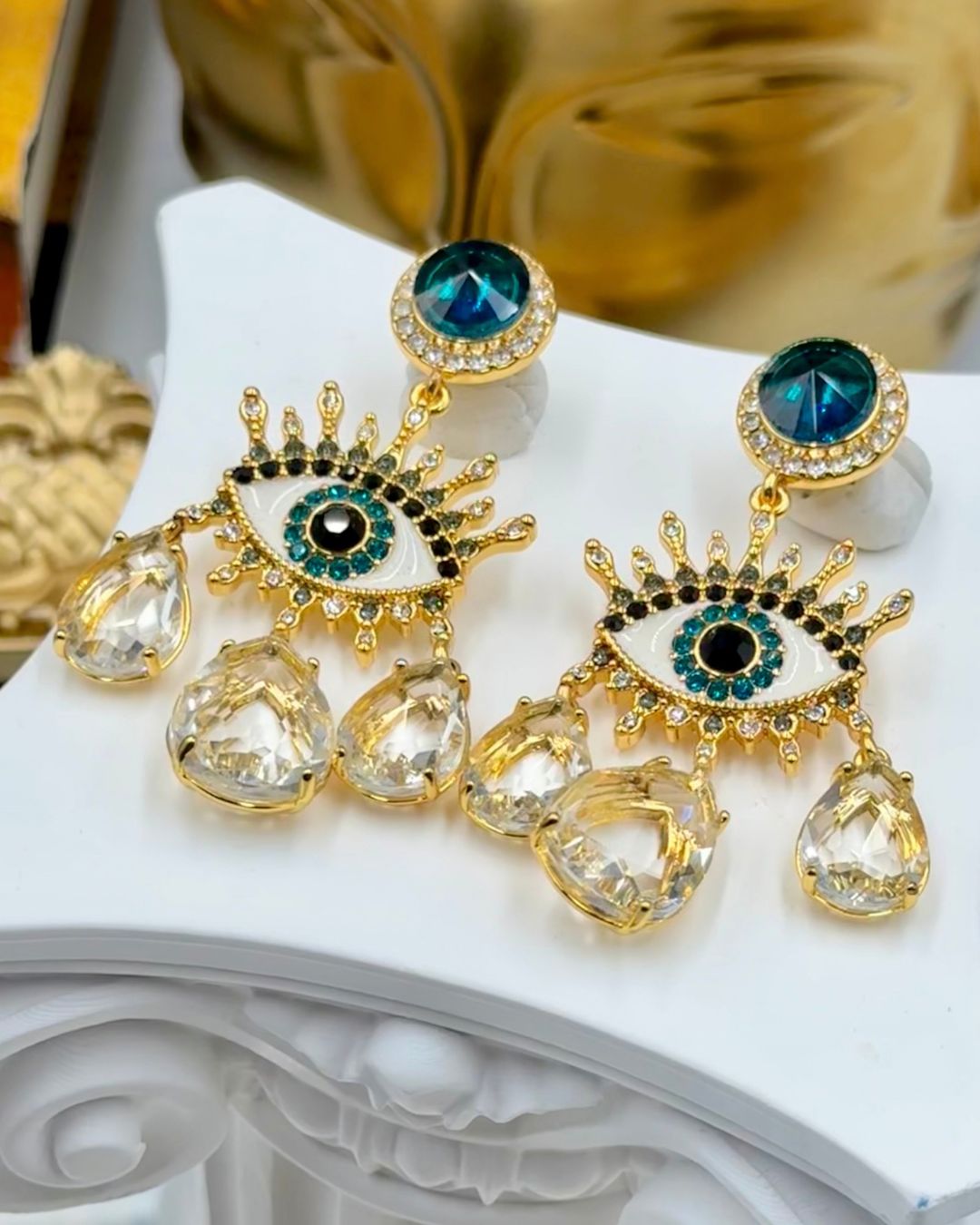 Pair of KURT GEIGER LONDON Evil Eye chandelier earrings with multicoloured crystals