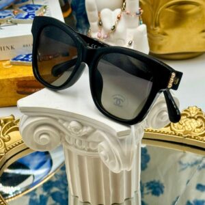 Folded CHANEL 5482H black acetate sunglasses with pearl CC detailing