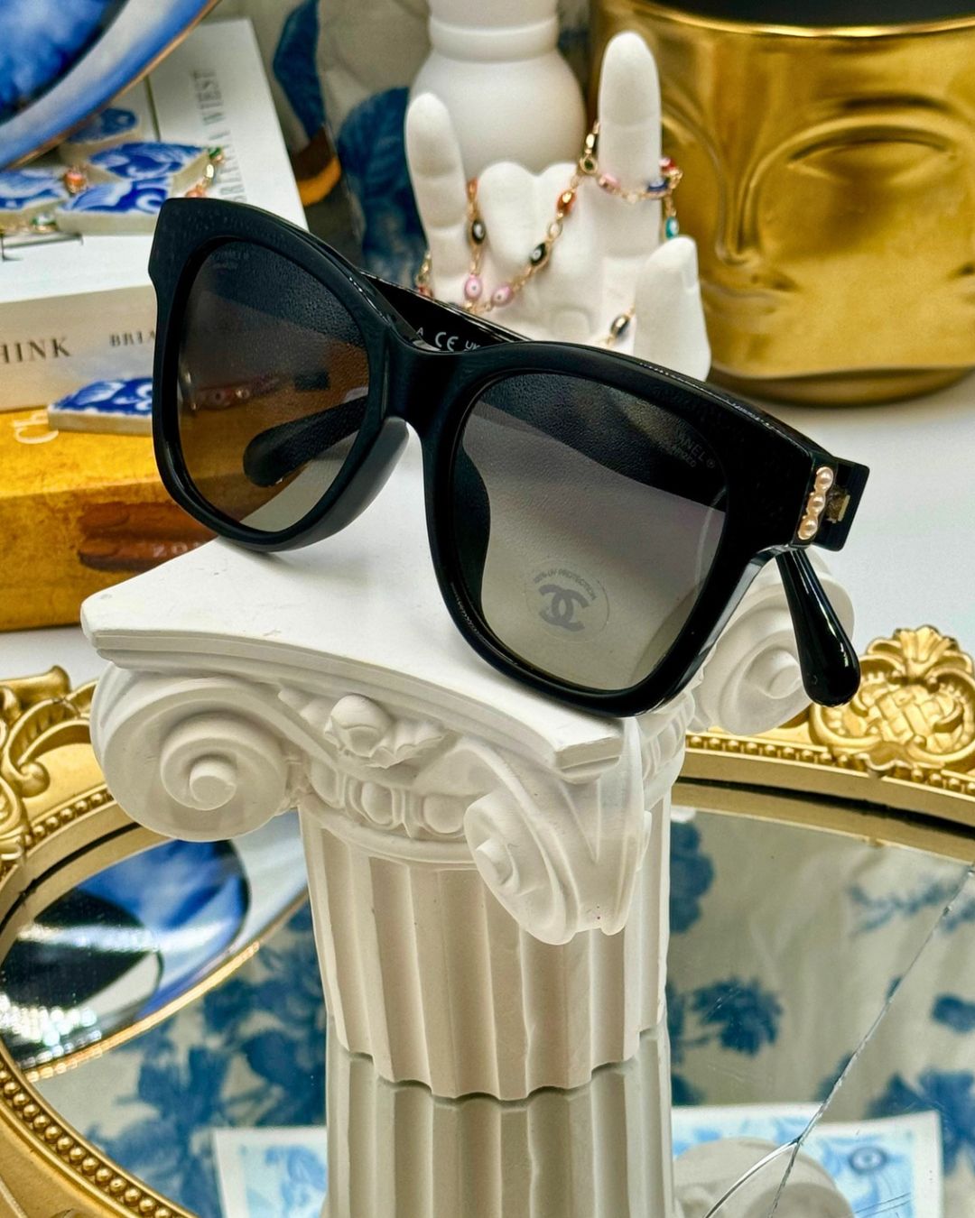 Folded CHANEL 5482H black acetate sunglasses with pearl CC detailing