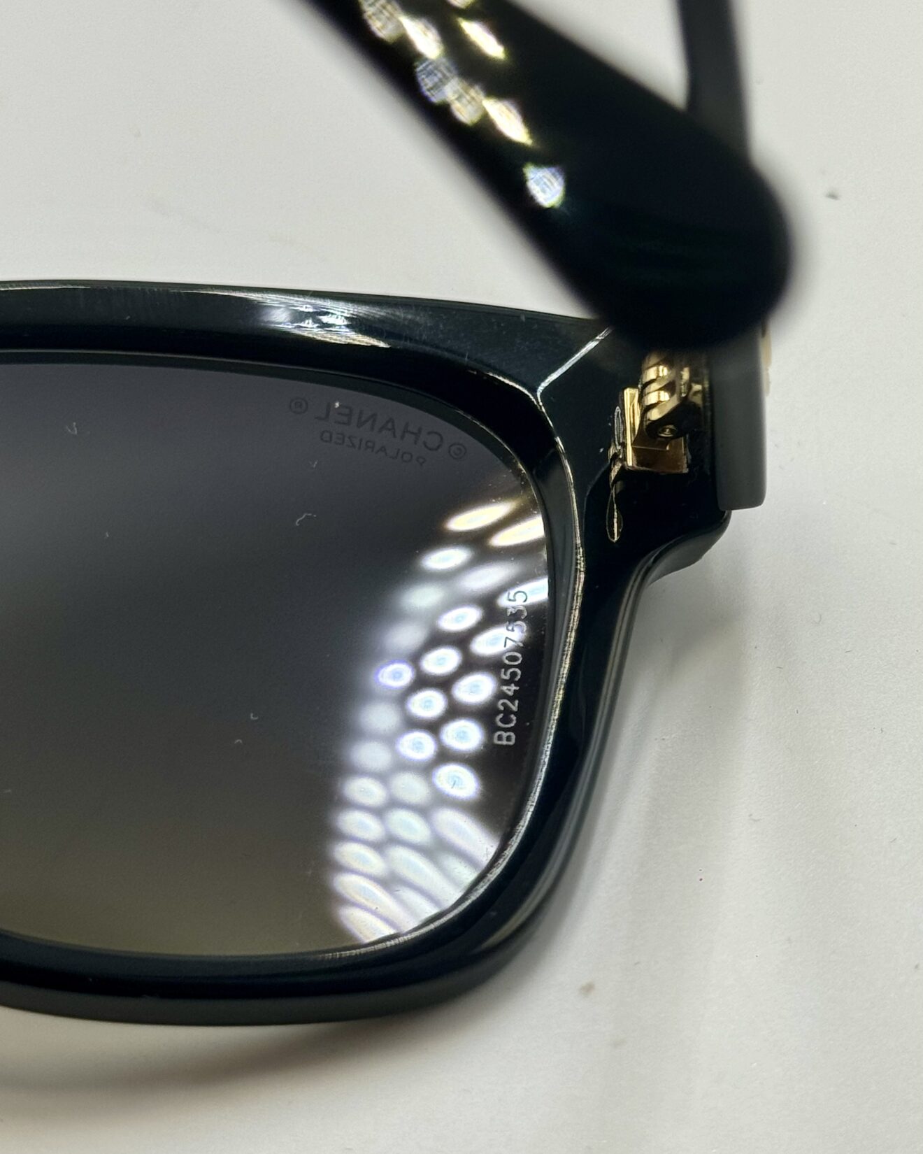 Grey polarized gradient lens and black acetate frame detail on CHANEL sunglasses