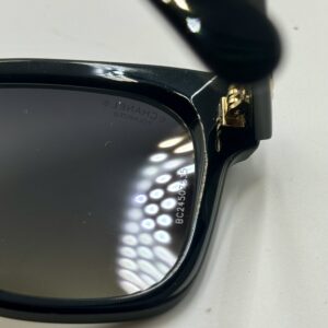 Grey polarized gradient lens and black acetate frame detail on CHANEL sunglasses