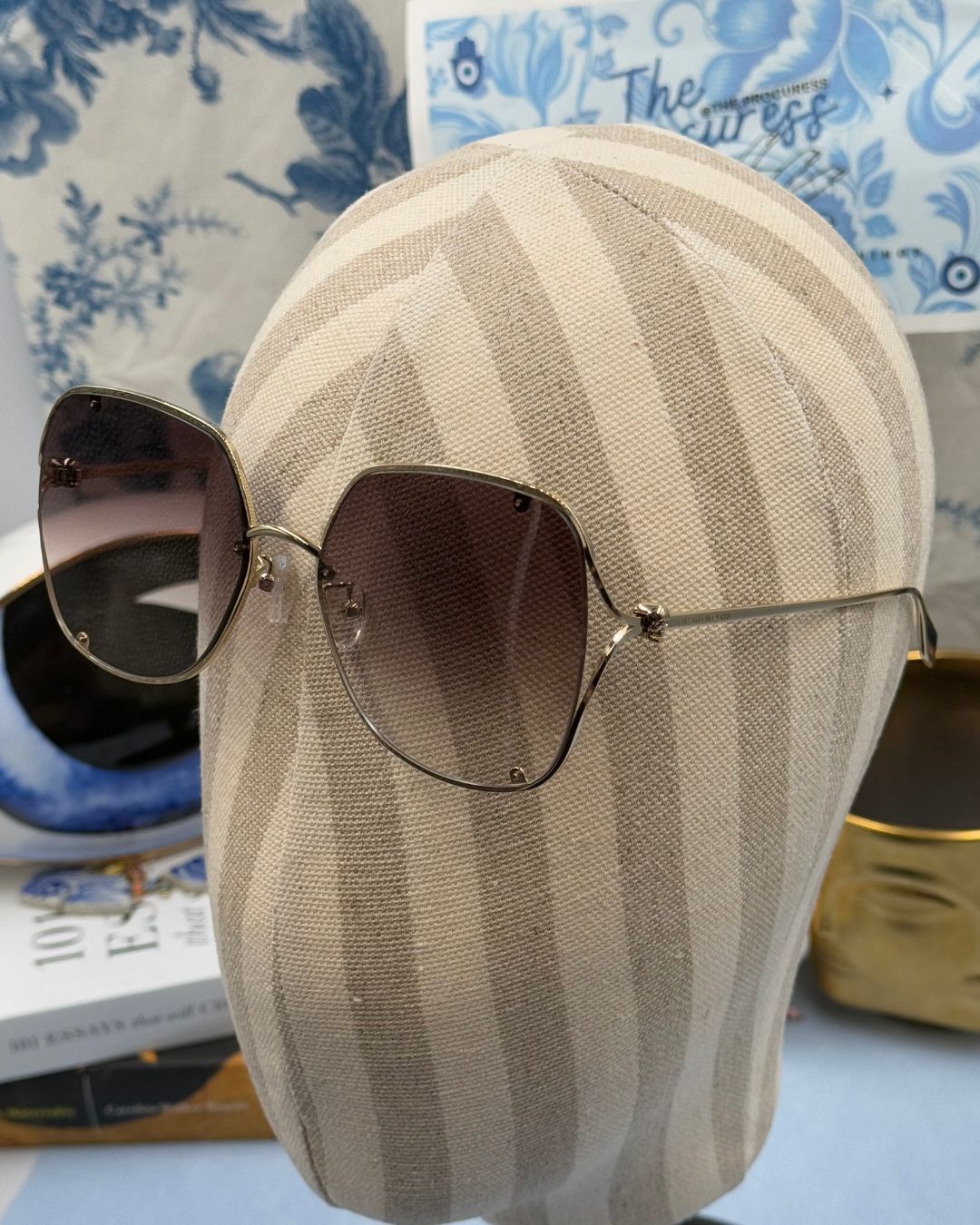 ALEXANDER McQUEEN AM0366S butterfly sunglasses in gold-tone metal with brown gradient lenses, modelled view