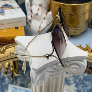 ALEXANDER McQUEEN AM0366S butterfly sunglasses in gold-tone metal with brown gradient lenses, side view
