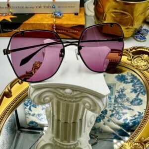 Folded view of black ALEXANDER McQUEEN AM0366S sunglasses with pink lenses