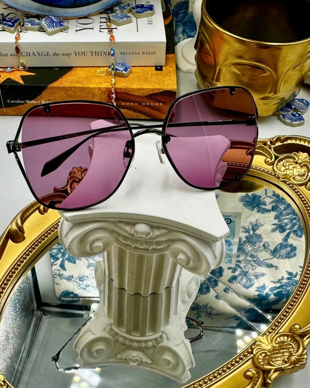 Folded view of black ALEXANDER McQUEEN AM0366S sunglasses with pink lenses