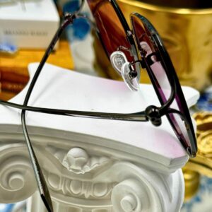 Side view of black and pink ALEXANDER McQUEEN butterfly sunglasses
