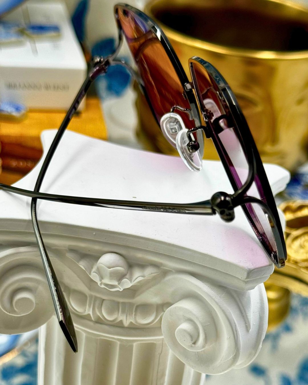 Side view of black and pink ALEXANDER McQUEEN butterfly sunglasses