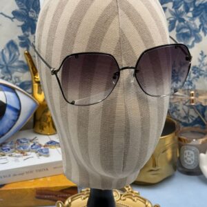 ALEXANDER McQUEEN AM0366S butterfly sunglasses in black metal with grey gradient lenses, modelled view