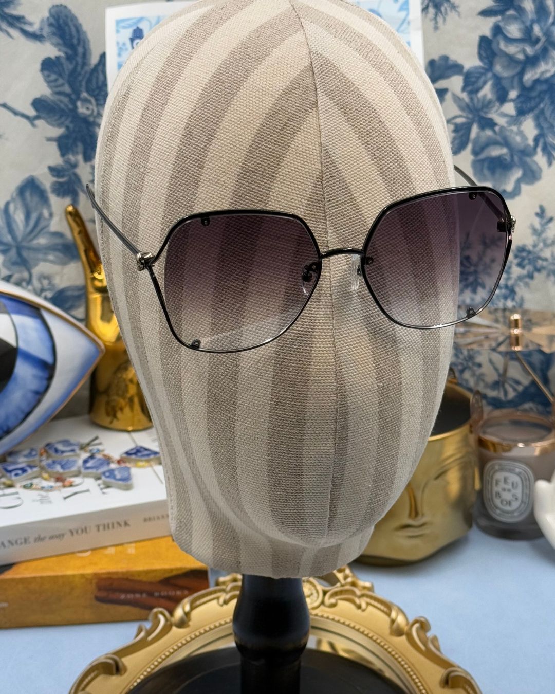 ALEXANDER McQUEEN AM0366S butterfly sunglasses in black metal with grey gradient lenses, modelled view