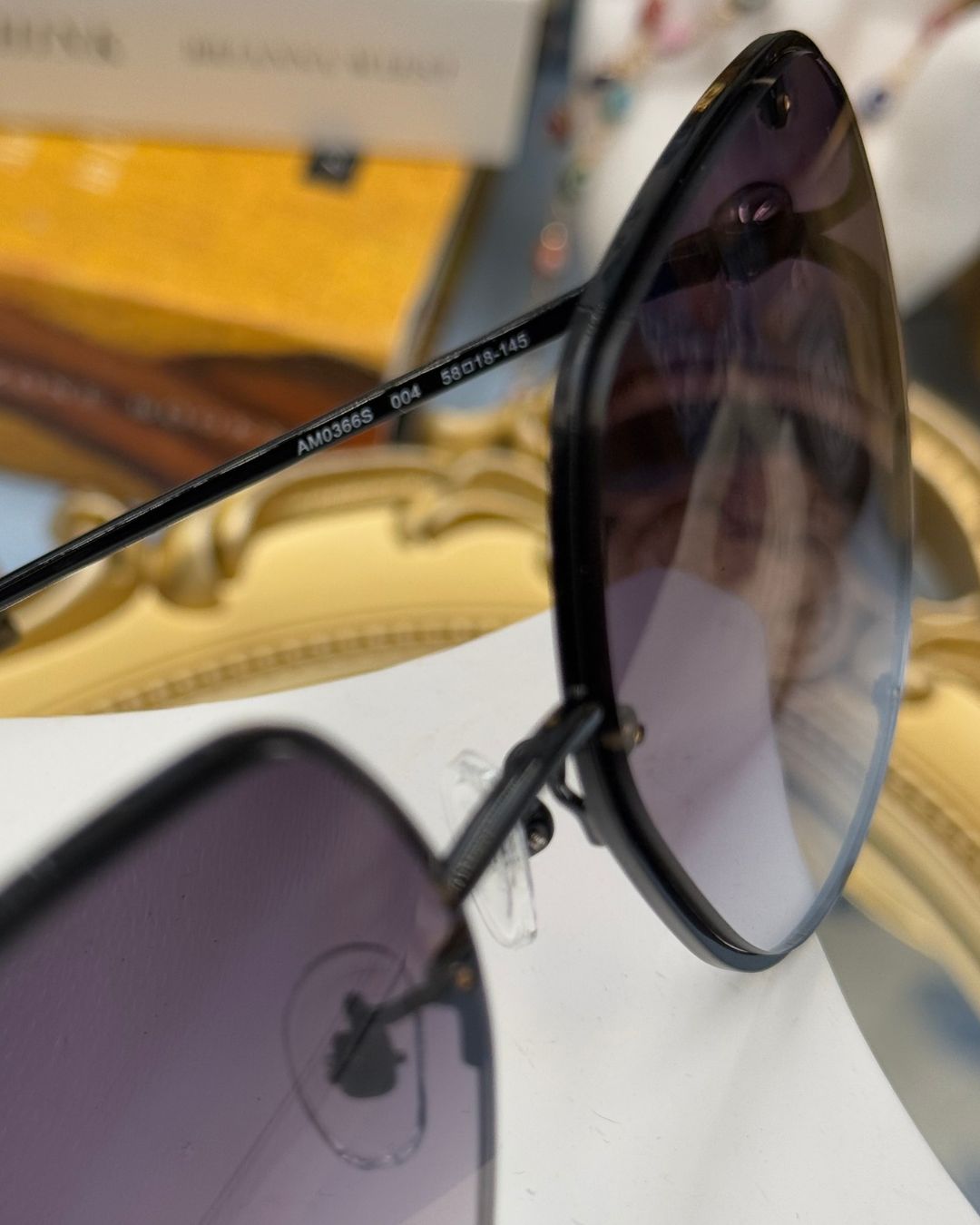 ALEXANDER McQUEEN AM0366S butterfly sunglasses in black metal with grey gradient lenses, style marking on temple