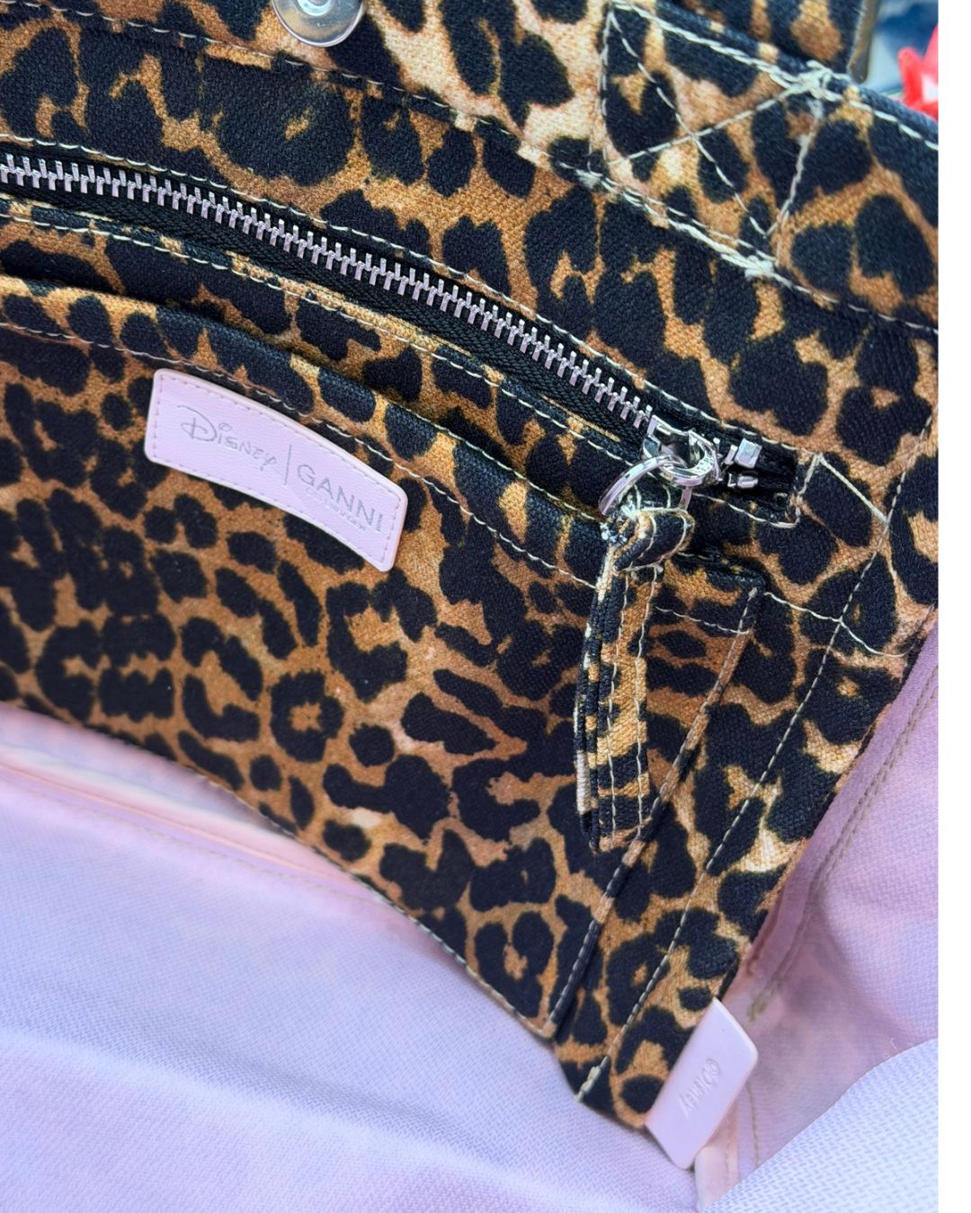 Interior zip and patch pockets of GANNI x DISNEY Daisy Duck Leopard Small Tote