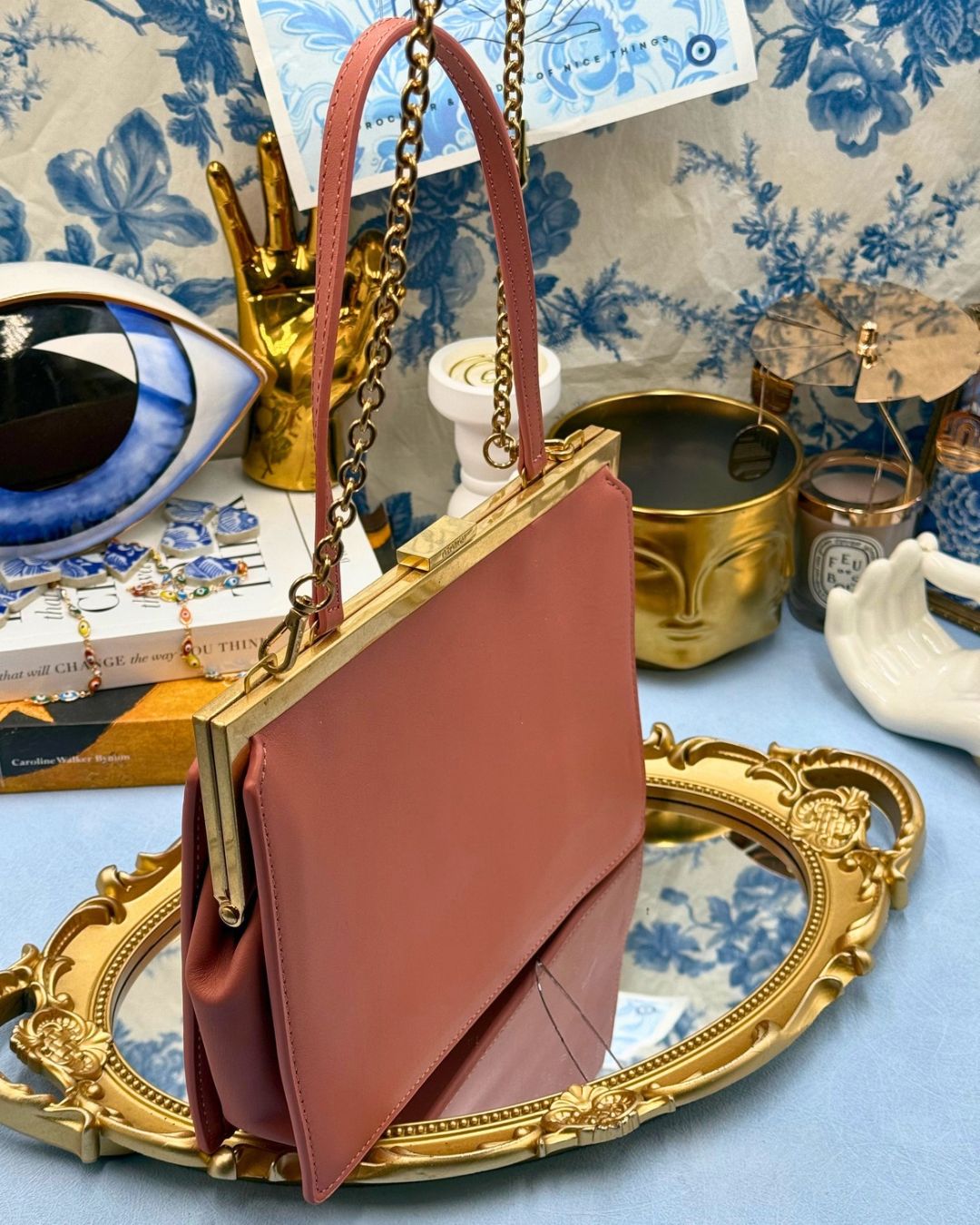 Angled view of Rosewood Pink OROTON Icon Frame Clutch