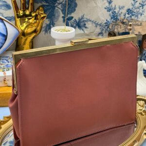 View of Rosewood Pink OROTON Icon Frame Clutch handheld