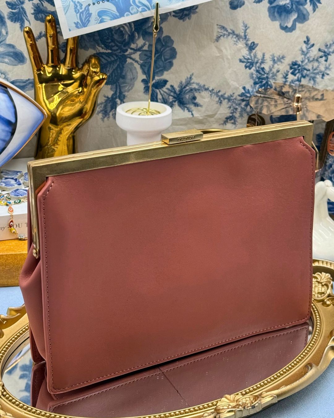 View of Rosewood Pink OROTON Icon Frame Clutch handheld