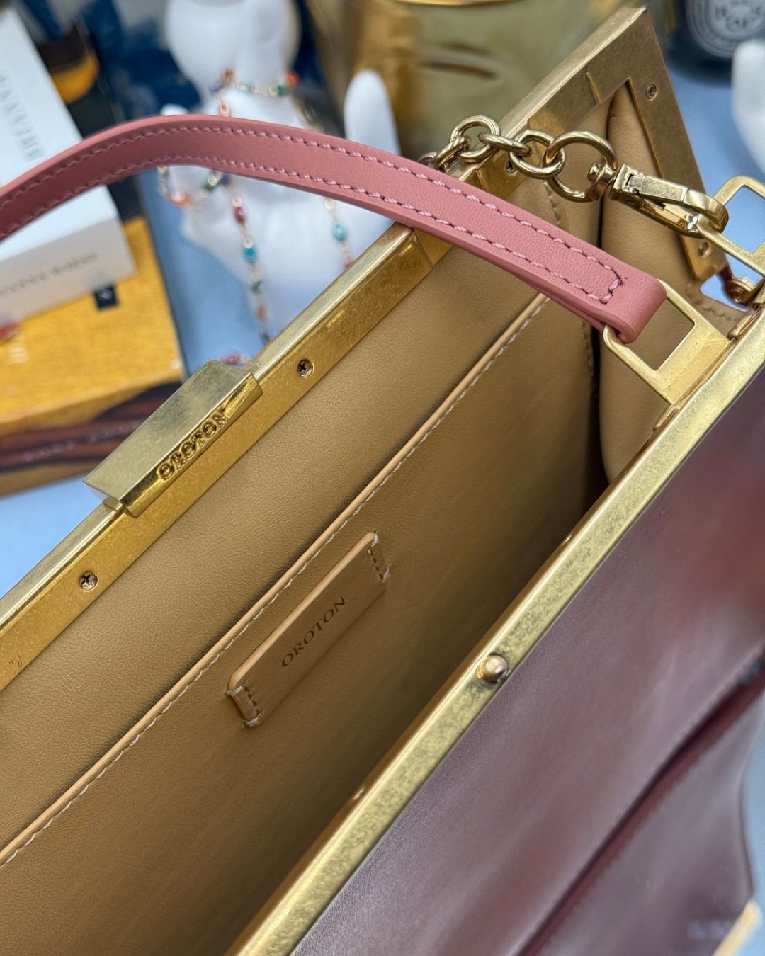 Kid-leather interior of Rosewood Pink OROTON Icon Frame Clutch