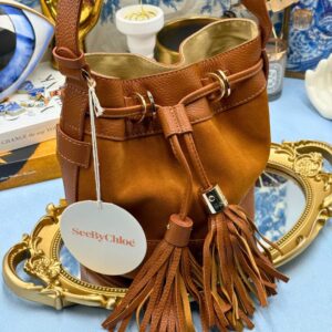 Angled view of SEE BY CHLOÉ Vicki Bucket Bag in Caramello