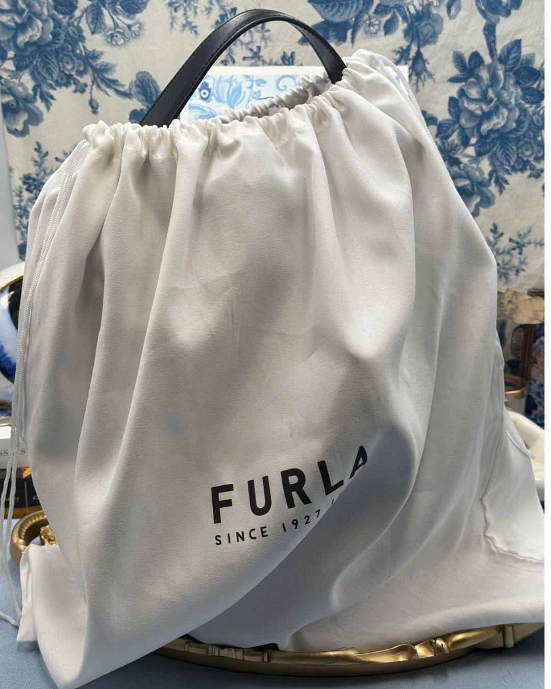 View of FURLA Constanza Black Leather Bucket Bag in FURLA dustbag
