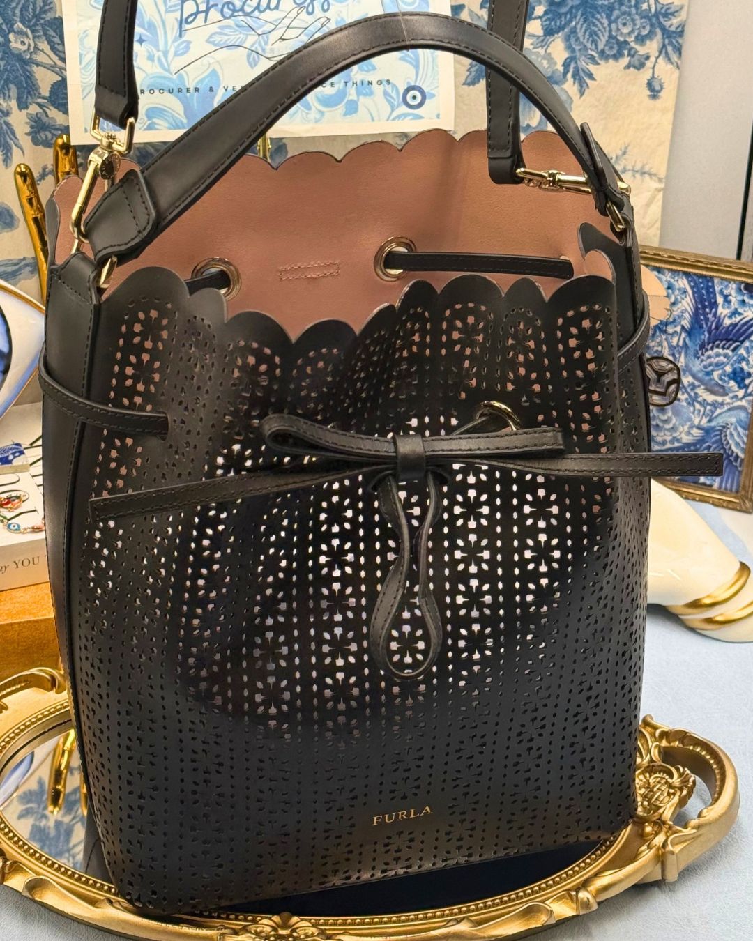 FURLA Constanza Laser-Cut Leather Bucket Bag in Black, front view