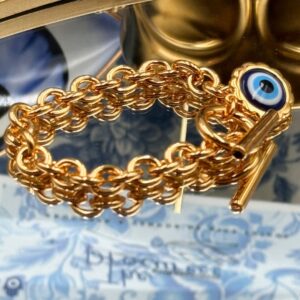 Angled view of LELE SADOUGHI Gold Evil Eye Charm Bracelet