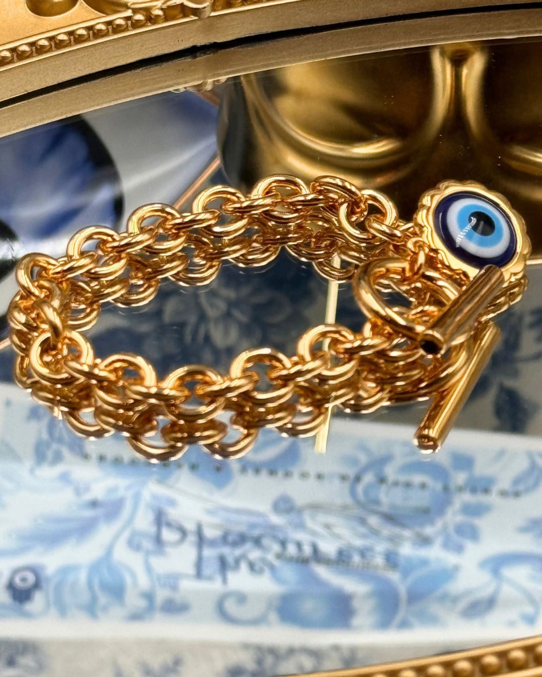 Angled view of LELE SADOUGHI Gold Evil Eye Charm Bracelet