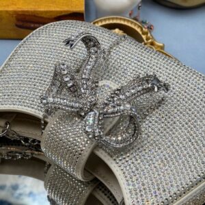 Crystal bow detail on SELF-PORTRAIT crescent bag