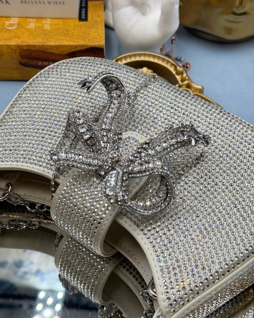 Crystal bow detail on SELF-PORTRAIT crescent bag