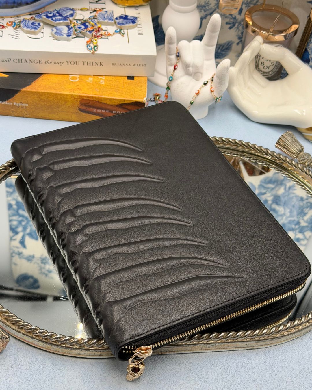 Back, embossed ribcage detail along ALEXANDER McQUEEN black leather portfolio