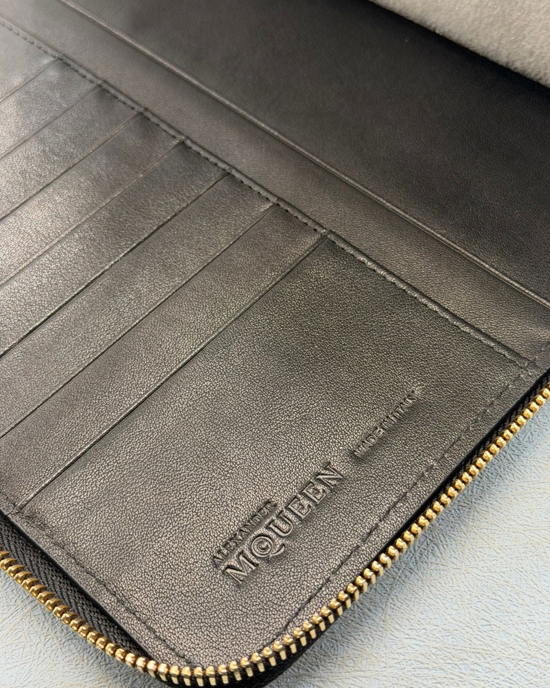 Made In & Logo Embossed inside ALEXANDER McQUEEN Skull embossed black leather portfolio with gold-tone hardware