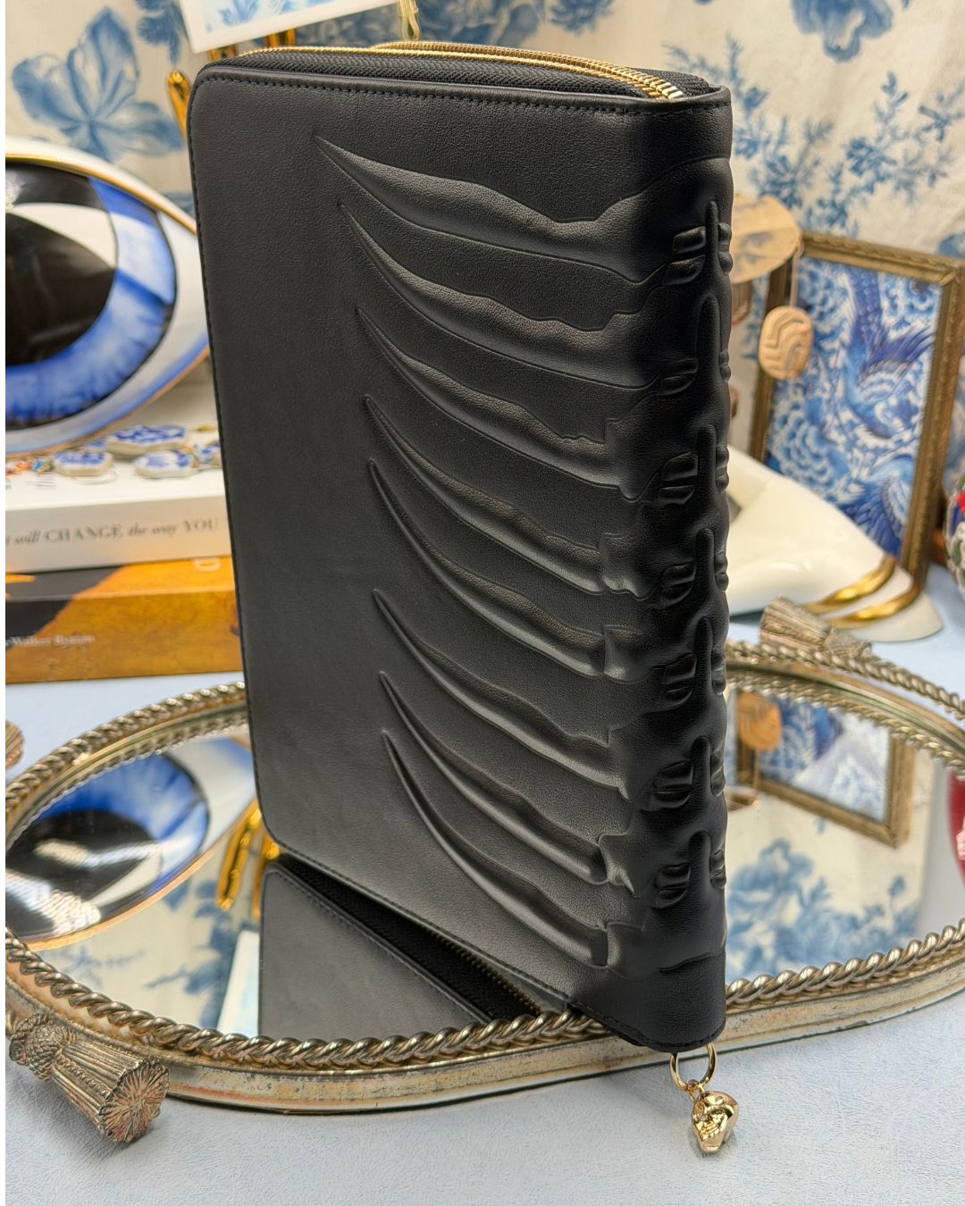 Embossed ribcage detail along ALEXANDER McQUEEN black leather portfolio