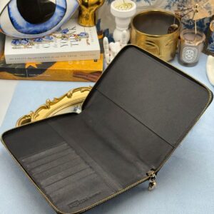 Interior of ALEXANDER McQUEEN Skull embossed black leather portfolio with gold-tone hardware